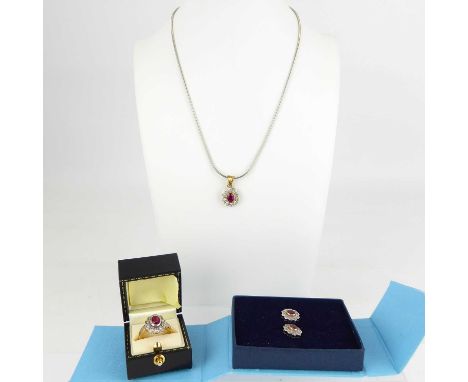 A suite of 9ct diamond and ruby jewellery consisting of pendant on chain, ring, pair of earrings, all with centred rubover se