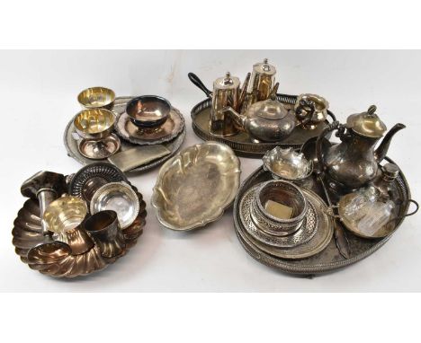 A large quantity of silver plated items including two large silver plated trays, a pair of coffee pots, teapots, wine coaster