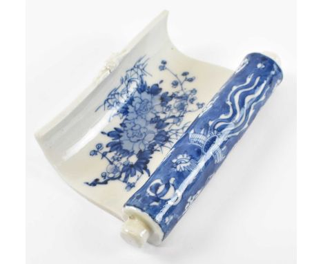 A Japanese Arita porcelain blue and white wrist rest modelled as a scroll, painted with a phoenix and floral bouquet, width 1
