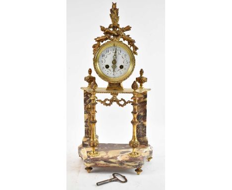 A late 19th century/early 20th century French marble and gilt metal eight day mantel clock with decorative white enamel dial,