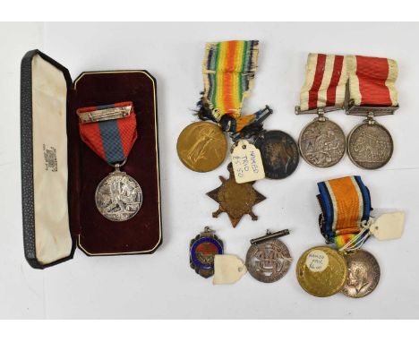 A group of WWI medals comprising a named trio of 1914-15 Star, War Medal and Victory Medal awarded to T. Tyson, a pair of nam