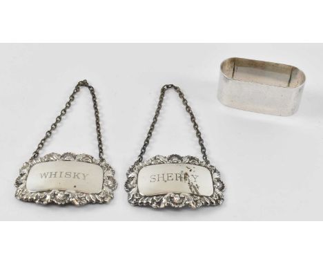 HENRY WILLIAMSON LTD; a George V hallmarked silver napkin ring, Birmingham 1924, a hallmarked silver 'Whisky' decanter label 