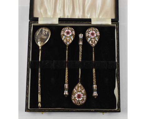 A set of three Russian 84 grade and enamel teaspoons and another Russian 84 grade spoon depicting street scene to the reverse