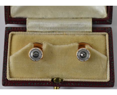 A pair of 15ct yellow gold buttons, set with small white stones and white enamel, combined approx 2.8g. 