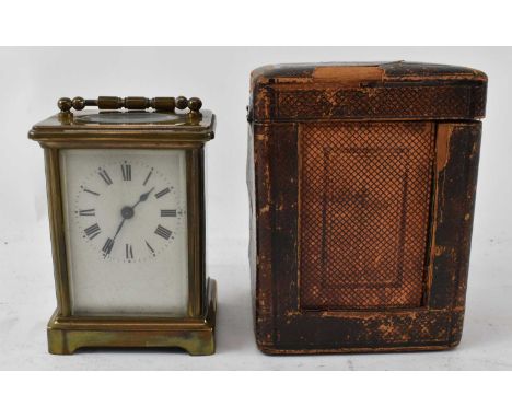 A late 19th/early 20th century brass cased carriage clock, height 11cm, complete with leather outer case and keys. 