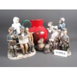 Two Nao figures, two Capodimonte figure groups, two Poole Pottery model birds, a red glazed jug