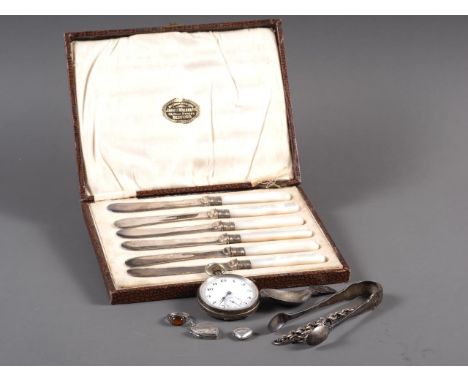 A Georgian silver caddy spoon, a pair of silver tongs, a silver cased pocket watch and a set of mother-of-pearl handled tea k