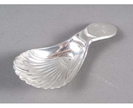 A Georgian silver caddy spoon with shell-shaped bowl and monogram 