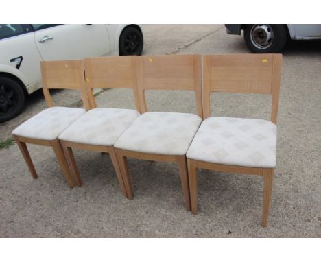 A set of four Ercol light oak dining chair with panel backs, on square taper supports