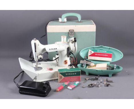 An electrical portable Singer sewing machine, model 221K, in case, with original tools and accessories