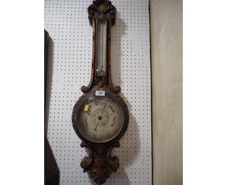 A carved oak barometer and thermometer, 33 1/4" high
