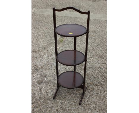 An early 20th century mahogany folding three-tier cake stand, 11" wide x 36" high, and a mahogany rectangular planter, on squ