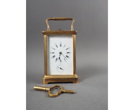 A brass cased carriage clock with white enamel dial and repeater alarm movement, 5 1/2" high