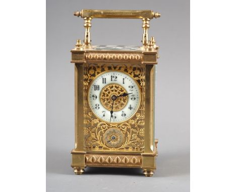 A gilt brass cased carriage clock with pierced and engraved dial and eight-day alarm movement, 6" high