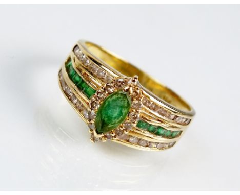 An emerald and diamond dress ring, designed as a central navette cut emerald within a border of brilliant cut diamonds, claw 