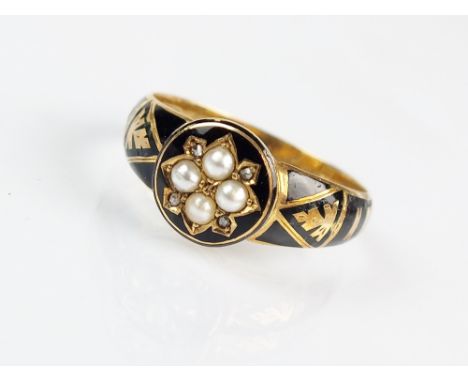 A late Victorian diamond, seed pearl and enamel mourning ring, designed as a central black enamel circular plaque set with fo