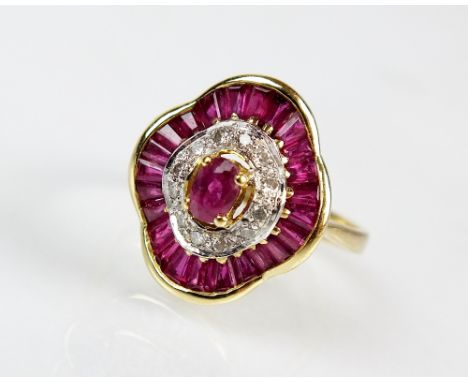 An 18ct gold ruby and diamond dress ring, designed as a central oval mixed cut ruby within an inner surround of brilliant cut