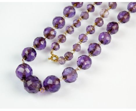 A graduated amethyst bead necklace, comprising sixty-three faceted amethyst beads, the yellow metal bolt ring clasp stamped '