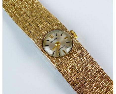 A lady's 9ct gold Gilroyal bracelet watch, the circular white dial with batons, manual wind, the bark finish bracelet hallmar