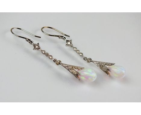 A pair of Art Deco style opal and diamond ear pendants, each designed as cabochon opal drop suspended by diamond set stylised