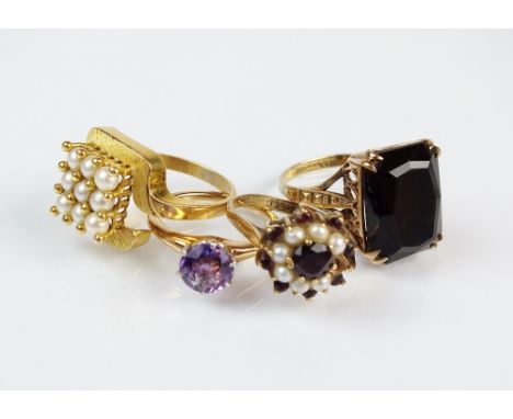 A 9ct gold smoky quartz dress ring, together with a garnet and seed pearl cluster ring and two further rings (4)