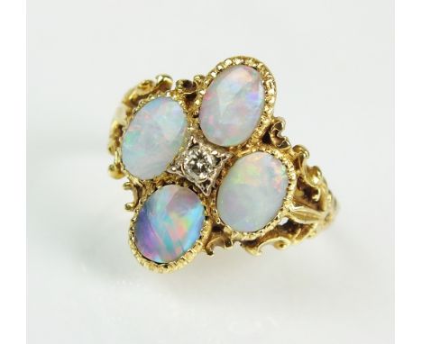 An 18ct gold Victorian style opal and diamond cluster ring, designed as a central brilliant cut diamond claw set within a sur