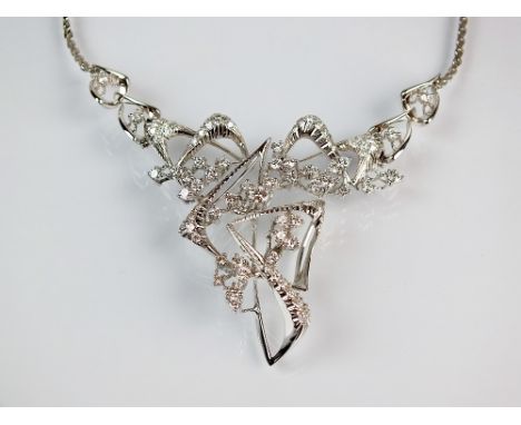 A diamond set stylised necklace, designed as graduated brilliant cut diamonds claw and pave set to textured white metal abstr