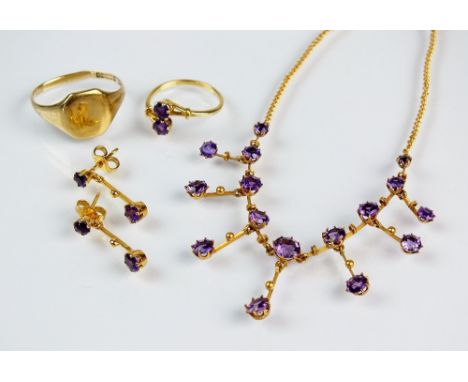 A matched suite of amethyst set jewellery, comprising; a graduated fringe necklace, stamped '9ct', a two stone crossover ring