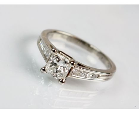 A platinum single stone princess cut diamond ring, the princess cut diamond within four claw platinum mount set to graduated 