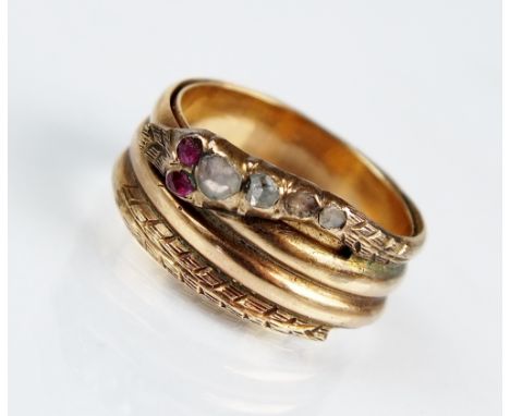 A mid 19th century diamond and ruby stylised snake ring, designed as a reeded yellow metal snakes body hoop with rose cut dia