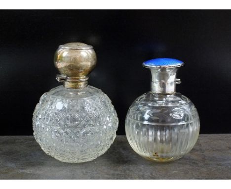 A silver topped glass scent bottle, F H Adams Ltd, Birmingham 1910, 12.5cm high, together with a silver and enamel topped gla