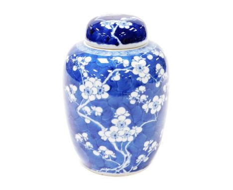 A Chinese blue and white porcelain ginger jar and cover, decorated with prunus blossom on a cracked ice ground, four characte