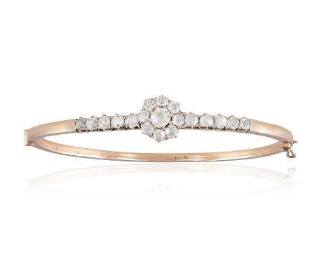A VICTORIAN DIAMOND BANGLE CIRCA 1890, the front of the bangle modelled as an old-cut diamond cluster, either side with simil