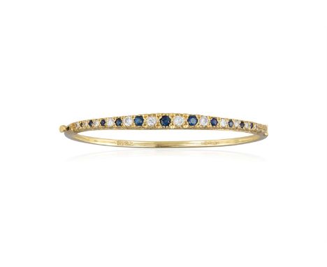 A SAPPHIRE AND DIAMOND BANGLE, the hinged bangle, set to the front with a graduated row of circular-cut sapphires each altern