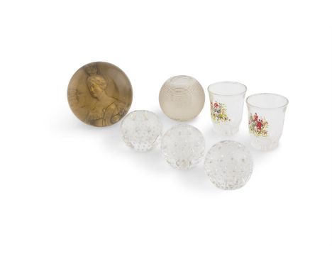 A 19TH CENTURY CLEAR GLASS PAPER WEIGHT, enclosing a depiction of Queen Victoria, 8.5cm diameter; together with three small s