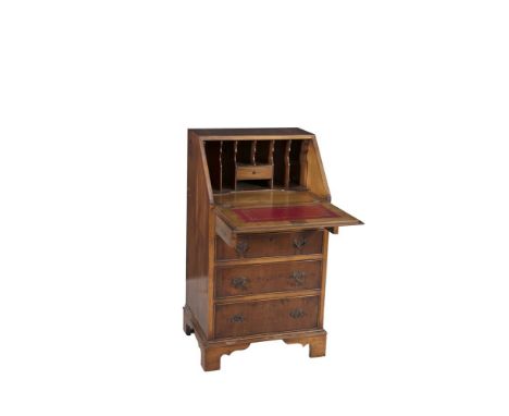 A SMALL YEW WOOD SLOPE FRONT BUREAU, with a crossbanded fall front panel fitted with gilt tooled scriver enclosing a fitted i