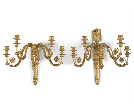 A PAIR OF FRENCH NEOCLASSICAL FIVE LIGHT GILTWOOD AND GESSO WALL SCONCES, each back plate with a classical urn and hung with 