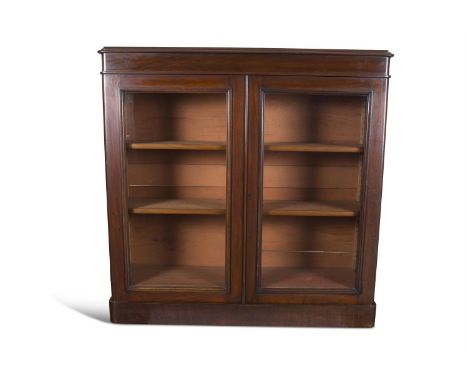 A VICTORIAN MAHOGANY TWO DOOR BOOKCASE, c.1860, of rectangular form, with thumb moulded top over twin glazed panel doors encl