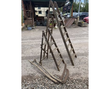 Two pairs of vintage step ladders also with two scythes. 