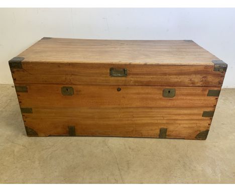 An early 20th century camphor wood  trunk with brass bound edges and metal handles to the sides.W:98cm x D:48cm x H:44cm