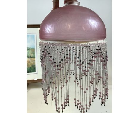 A pink frosted lamp shade with beaded decoration together with a brass shade with beaded decoration for restoration circa 192