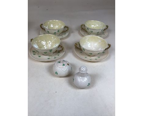 Belleek porcelain decorated in the Shamrock pattern - 4 soup cups and saucers, a mustard pot and a pepper pot 