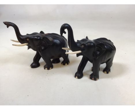 Two ebony elephants. Tallest 18cm to top of trunk