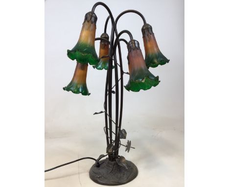 A 6 light table lamp in the style of Dale Tiffany decorated with dragonflies and lilies. A solid base with lamp weighing 13lb