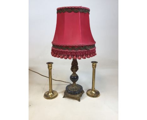 A black marble and gilt table lamp with red fringed shade together with a pair of candlesticks W:26cm x H:55cm Dimensions inc