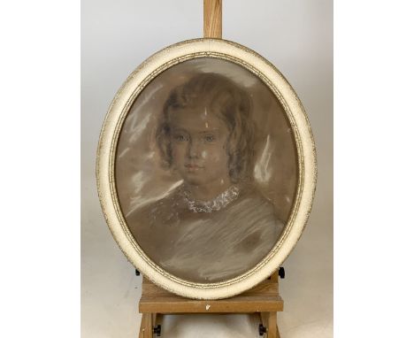 A Victorian pencil and pastel portrait of a young girl in oval frame. Signed lower right indistinct signature. Studio label v