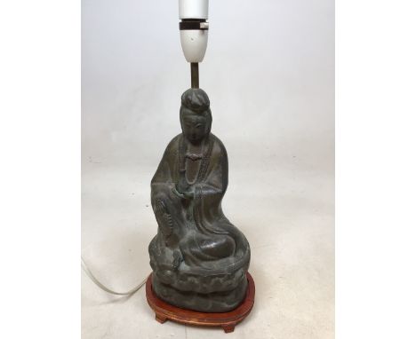 A bronzed metal buddah converted to a table lamp. Base sits on wooden plinth H:30cm to top of head 