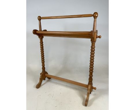 A bobbin twist light wood towel rail. W:75cm x D:24cm x H:87cm