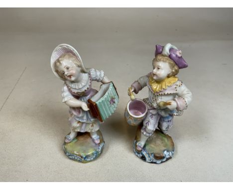 A pair of continental figures of a boy and girl playing drums and accordion H:14cm