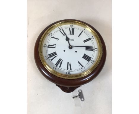 A Comitti Eight day bell strike movement. 10 inch dial with enamel finish and lacquered brass fittings W:33cm x D:13cm x H:37